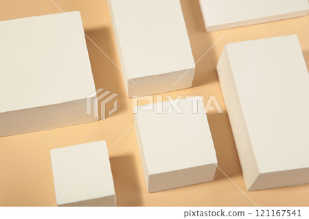 White square podiums on beige background. Trend fashion showcase for cosmetic products, goods, shoes, bags, watches. White square podiums on beige background. Trend fashion showcase for cosmetic products, goods, shoes, bags, watches. 121167541