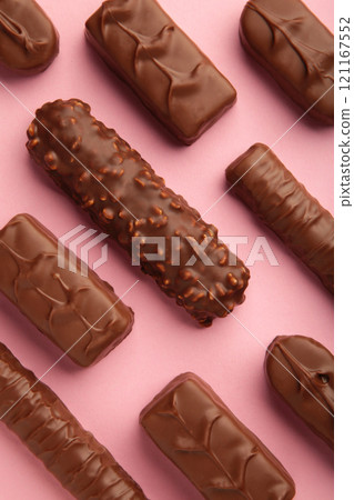 Mix of chocolate bars on pink background. Top view. Mix of chocolate bars on pink background. Top view. 121167552