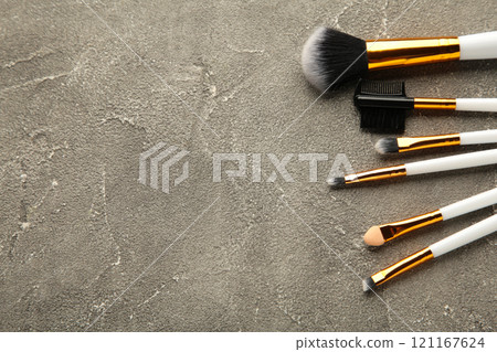 Set of makeup brushes on grey background. 121167624