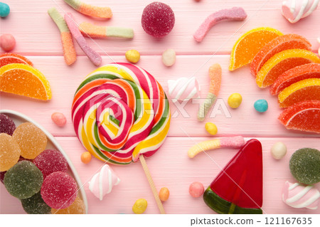 Colorful candies lollipops and jelly on pink background. Top view. Sweets 121167635