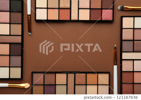 Professional makeup palette with brushes on brown background. Make up cosmetics 121167636