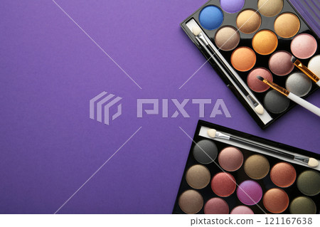 Professional makeup palette with brushes on purple background. Make up cosmetics 121167638