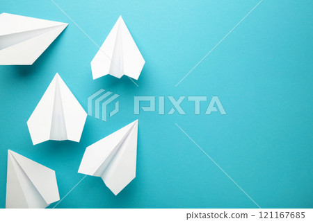 White paper airplanes on a blue background 121167685