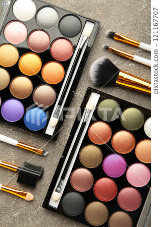 Professional makeup palette with brushes on grey background. Vertical photo. 121167707