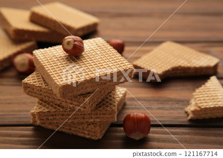 Chocolate wafers on brown background with hazelnut. Chocolate wafers on brown background with hazelnut. 121167714