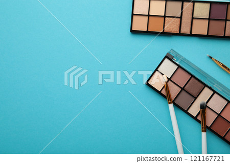 Professional makeup palette with brushes on blue background. Make up cosmetics 121167721