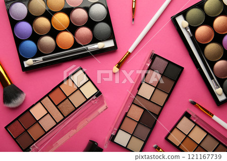 Professional makeup palette with brushes on pink background. Professional makeup palette with brushes on pink background. 121167739