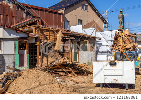 Demolition of an old wooden house 121168861