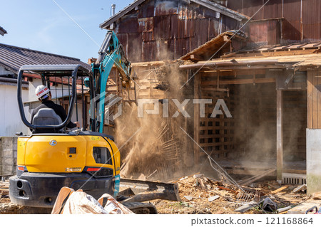 Demolition of an old wooden house 121168864