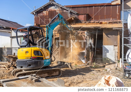 Demolition of an old wooden house 121168873