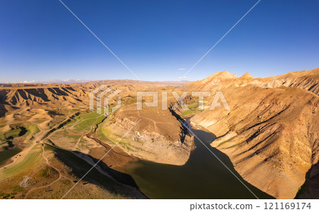 Panoramic aerial view on picturesque Azat reservoir and Eranos mountain at bright sunny evning sunset. Lake with blue water in arid area and Yeranos mountains range. Beautiful landscape. Armenia. 121169174