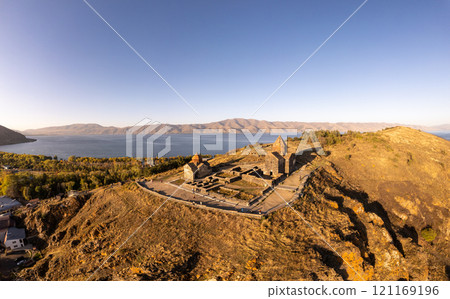 Aerial panoramic view of Surp Arakelots Holy Apostles church and chapel. Ancient Sevanavank Monastery complex and Sevan lake on sunny summer day. Travel and tourist destinations. Armenia, Europe. Aerial panoramic view of Surp Arakelots Holy Apostles church and chapel. Ancient Sevanavank Monastery complex and Sevan lake on sunny summer day. Travel and tourist destinations. Armenia, Europe. 121169196