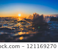 Frosty air and frozen lake surface in a beautiful sunset landscape. Beautiful ice shapes and sunlight. Photo from Sotkamo, Finland. 121169270