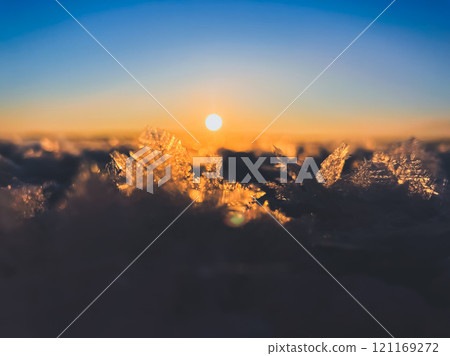 Frosty air and frozen lake surface in a beautiful sunset landscape. Beautiful ice shapes and sunlight. Photo from Sotkamo, Finland. 121169272