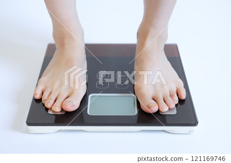 Feet on a weight scale Diet image 121169746