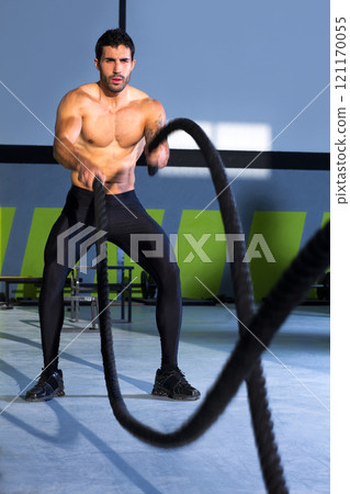 Crossfit battling ropes at gym workout exercise 121170055