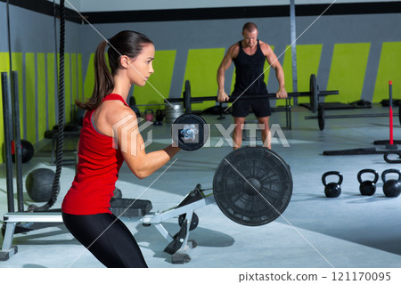 girl dumbbell and man weight lifting bar workout girl dumbbell and man weight lifting bar workout 121170095