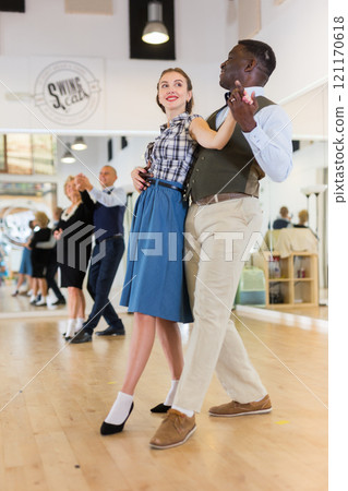Woman with american man practising ballroom dancing Woman with american man practising ballroom dancing 121170618