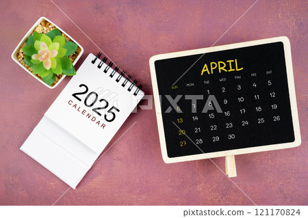 Calendar for April 2025 in black chalkboard on red wooden. 121170824