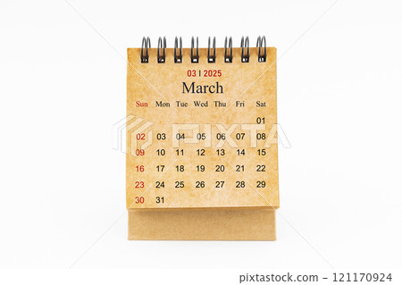 Brown mini desk calendar for March 2025 isolated on white. 121170924