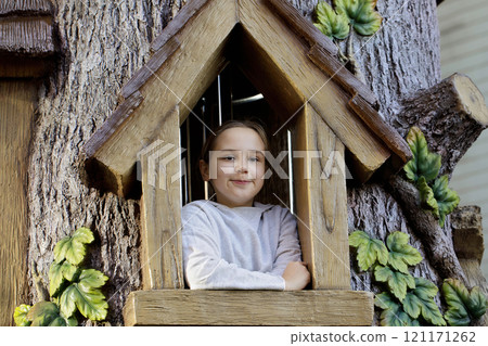 Cheerful young girl. Child on playground. Kids play outdoors.  121171262