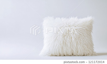 Fluffy white pillow resting on a white background 121172014