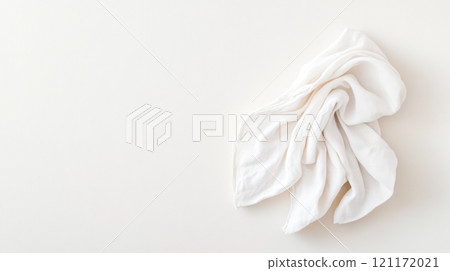 White cloth napkin folded on neutral background with copy space 121172021