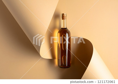 Bottle of white wine on a beige background. 121172061