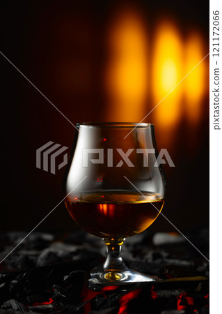 Snifter of brandy on a burning charcoal. Snifter of brandy on a burning charcoal. 121172066