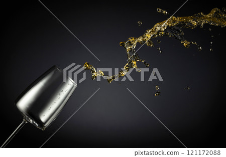 Glass and white wine splash on a black background. Glass and white wine splash on a black background. 121172088