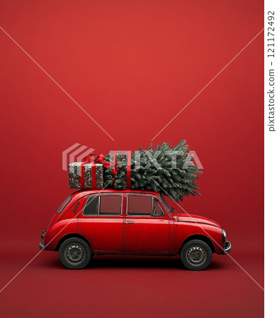 Classic red auto transporting an undecorated Christmas tree with gifts on a vibrant red background Classic red auto transporting an undecorated Christmas tree with gifts on a vibrant red background 121172492