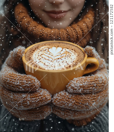 Cozy winter day with warm coffee in hands wearing mittens surrounded by falling snow 121172582