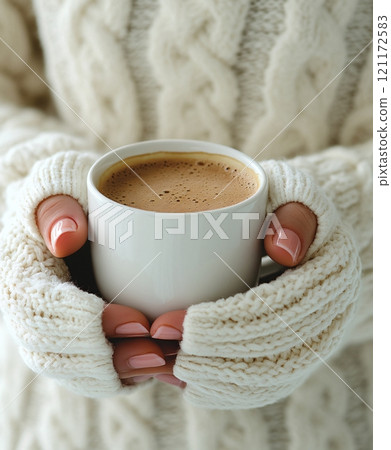 Enjoying a warm cup of coffee with winter mittens on a chilly day Enjoying a warm cup of coffee with winter mittens on a chilly day 121172583