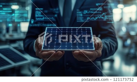 Businessman holding solar panel with digital data displaying renewable energy potential 121173752