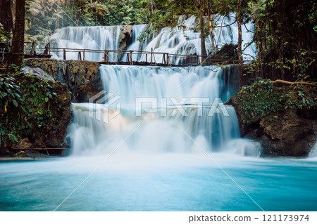Cascade waterfalls with blue water and wooden bridge in Central Sulawesi Cascade waterfalls with blue water and wooden bridge in Central Sulawesi 121173974