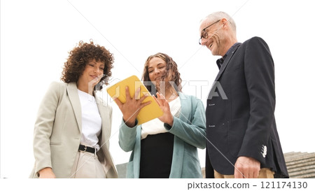 Businesspeople working on project using tablet near steps 121174130