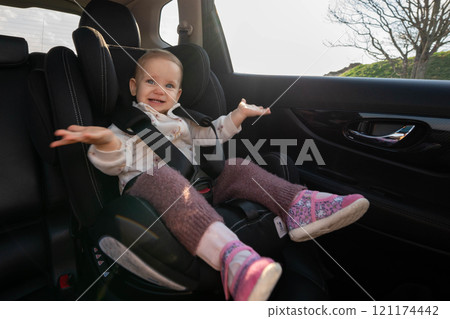 Unhappy toddler in car seat during journey. Concept of child safety, secure travel, and family road trips Unhappy toddler in car seat during journey. Concept of child safety, secure travel, and family road trips 121174442