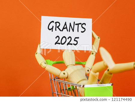Planning grants 2025 new year symbol. Concept words Grants 2025 on beautiful white paper on wooden clothespin. Beautiful orange background. Business grants 2025 new year concept. Copy space. 121174490