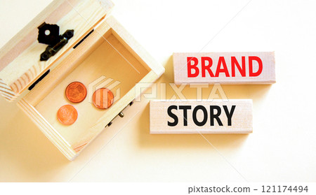 Brand story branding symbol. Concept words Brand story on beautiful wooden blocks. Beautiful white background. Wooden chest with coins. Business brand story branding concept. Copy space. 121174494