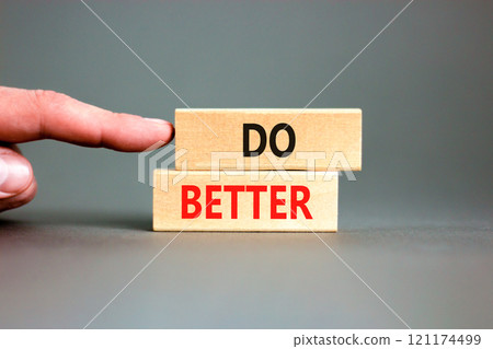 Do better symbol. Concept words Do better on beautiful wooden blocks. Beautiful grey background. Businessman hand. Business and do better concept. Copy space. 121174499