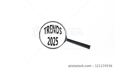 Planning trends 2025 new year symbol. Concept words Trends 2025 on beautiful white paper in magnifying glass. Beautiful white paper background. Business trends 2025 new year concept. Copy space. Planning trends 2025 new year symbol. Concept words Trends 2025 on beautiful white paper in magnifying glass. Beautiful white paper background. Business trends 2025 new year concept. Copy space. 121174556
