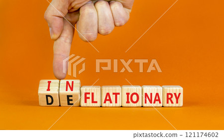 Deflationary or inflationary symbol. Concept words Deflationary Inflationary on wooden blocks. Beautiful orange background. Businessman hand. Business deflationary inflationary concept. Copy space 121174602