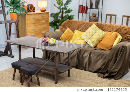 A Cozy Living Room featuring Stylish Decor and a Comfortable Sofa for a warm atmosphere 121174825