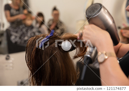 A Professional Hair Styling Session in Full Action, Showcasing Skill and Elegance A Professional Hair Styling Session in Full Action, Showcasing Skill and Elegance 121174877