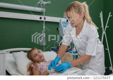 A Compassionate Nurse Attending to a Child Patient in the Hospital with Utmost Care and Kindness A Compassionate Nurse Attending to a Child Patient in the Hospital with Utmost Care and Kindness 121175077