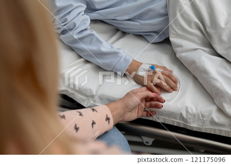 Compassionate Care Holding Hands in a Hospital Room to Provide Comfort and Connection 121175096