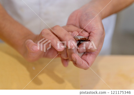 The hands of a sushi chef making sushi, sushi chef The hands of a sushi chef making sushi, sushi chef 121175346
