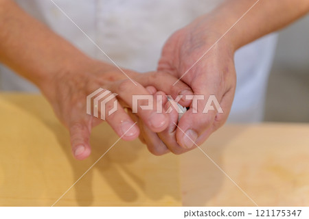The hands of a sushi chef making sushi, sushi chef 121175347