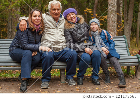 Happy family generation in park in autumn, portrait Happy family generation in park in autumn, portrait 121175563