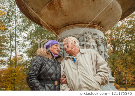 Adult man and woman in love on walk in autumn park 121175570